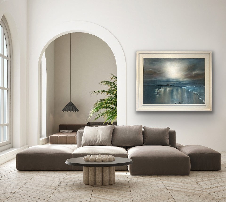 A softly lit living room with neutral tones and a large colourful painting above the sofa, adding warmth and vibrancy to the muted décor.